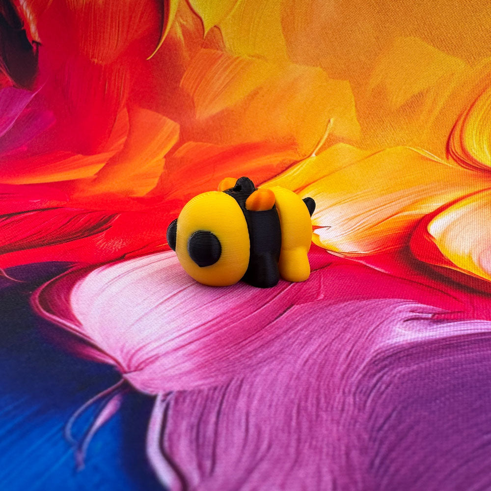 Toy bee on a colorful abstract background