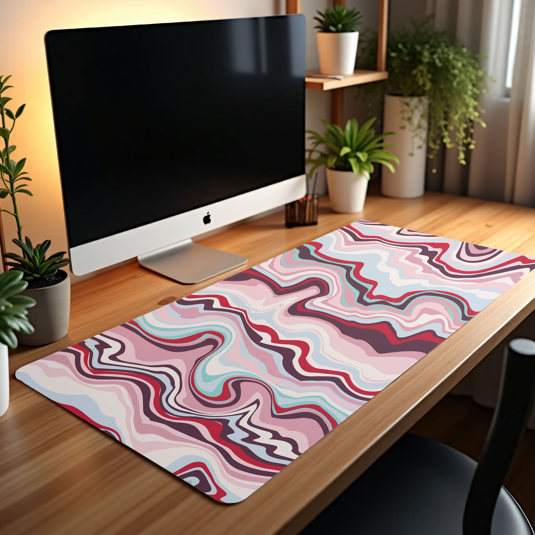 Desk setup with a computer monitor and colorful desk mat on a wooden surface.