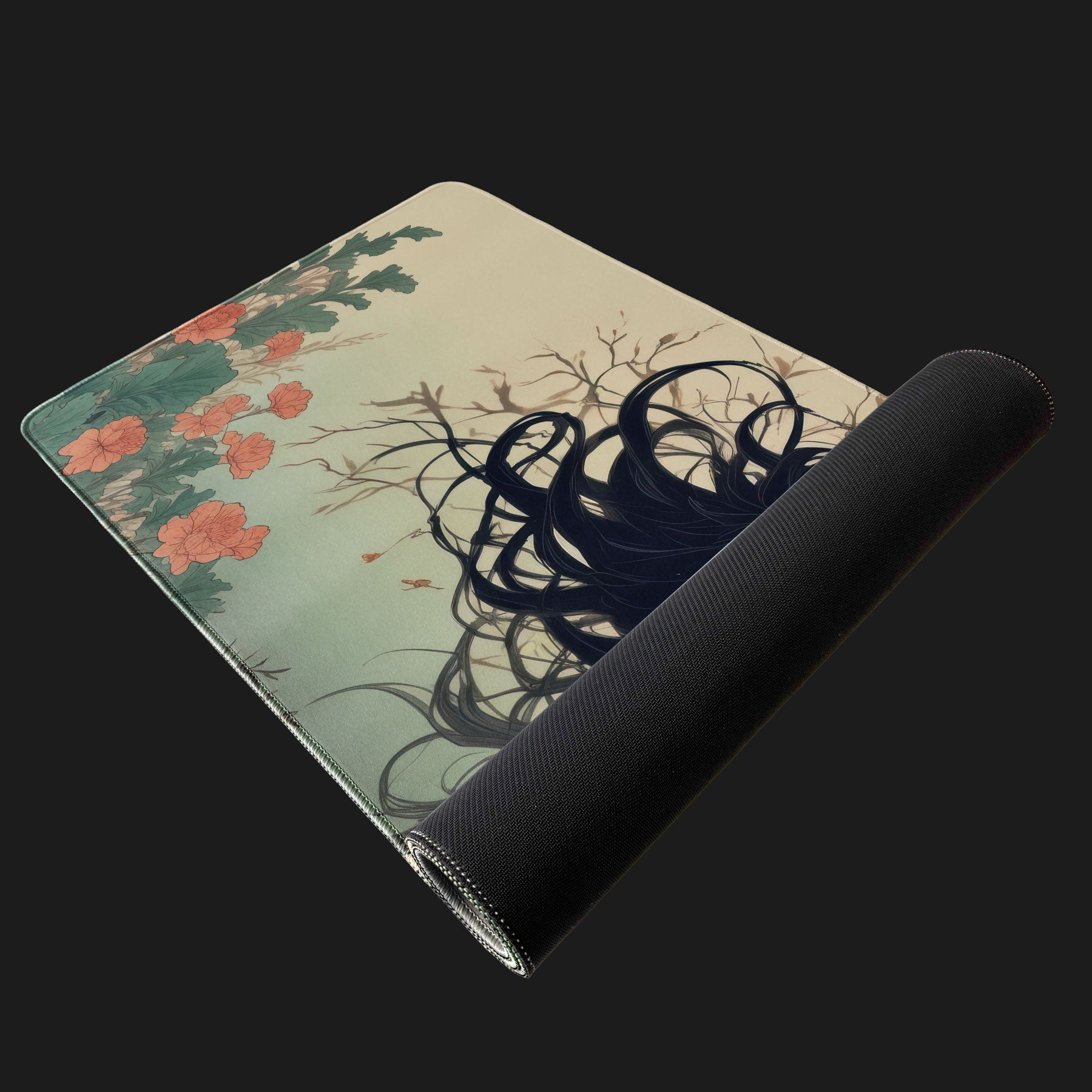 Desk mat with a floral and tree design on a black background