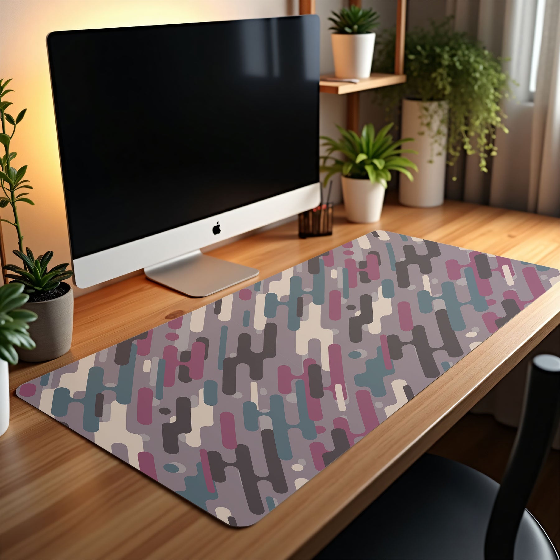Desk setup with a computer monitor and geometric patterned mouse pad.