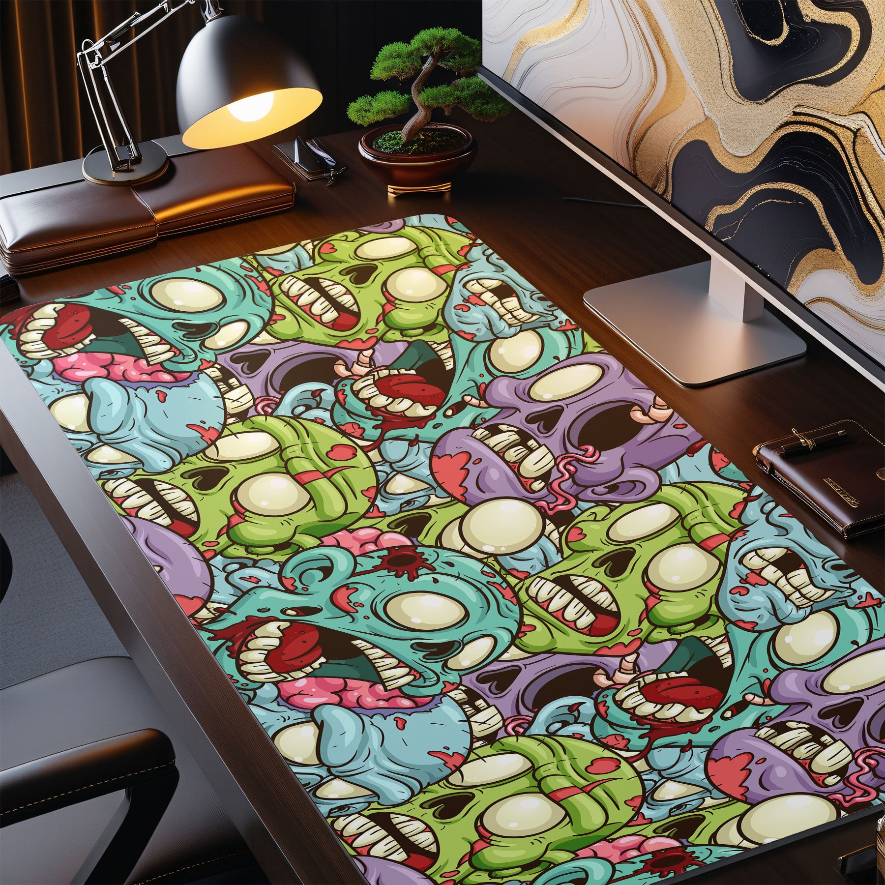 Colorful skull patterned desk mat on a desk with a computer setup.