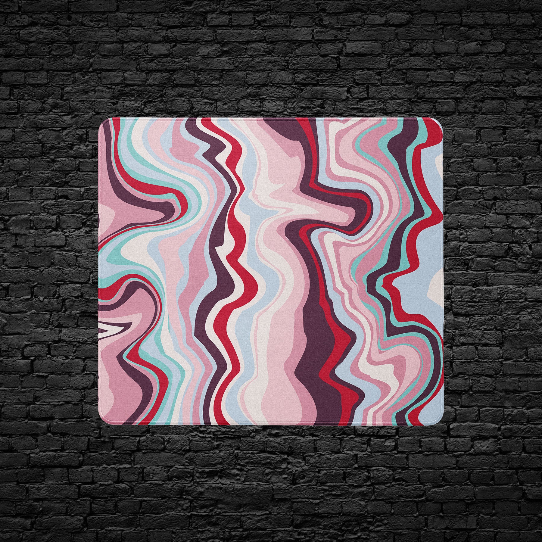 Colorful wavy patterned mouse pad on a black brick wall background