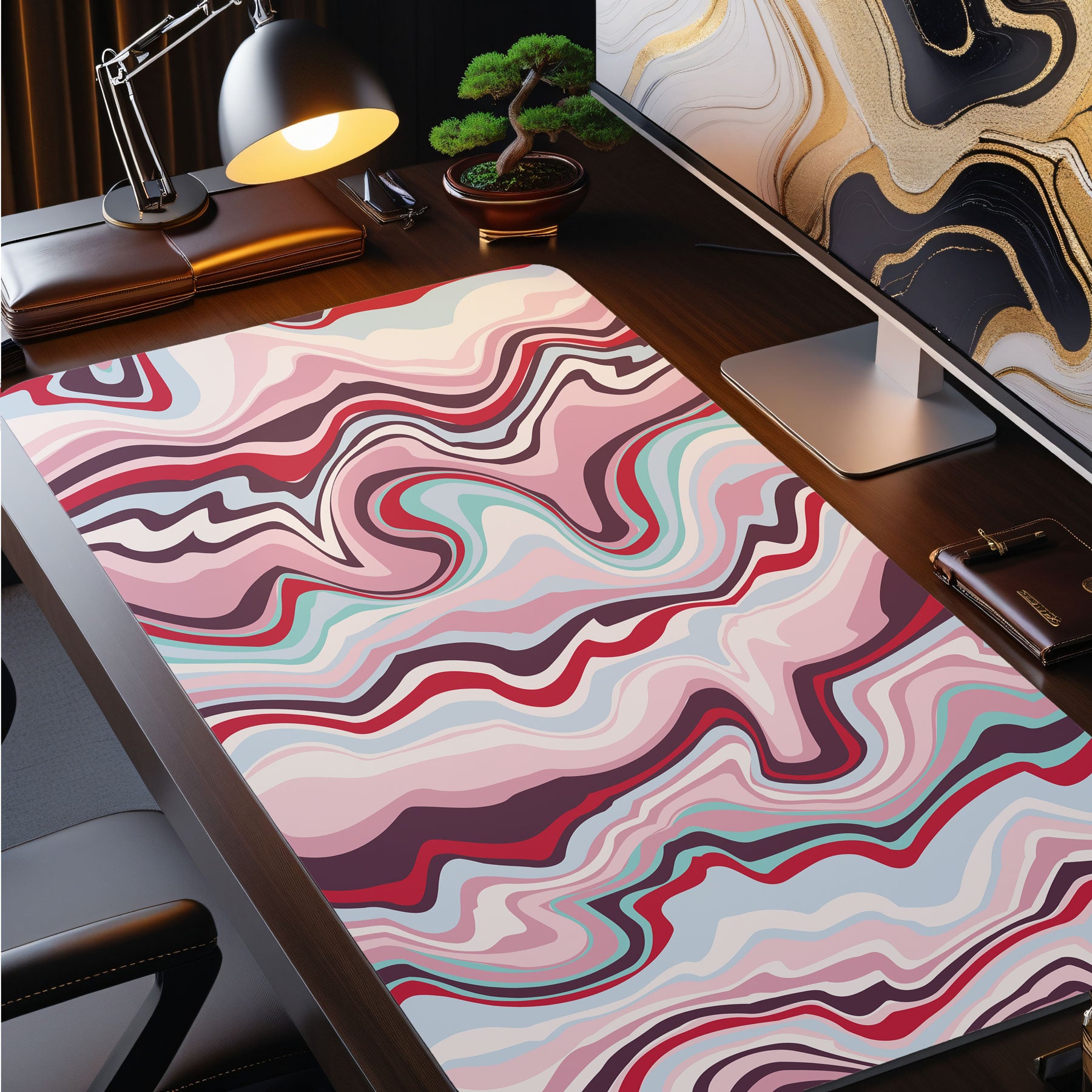 Colorful abstract desk mat on a desk with office items.