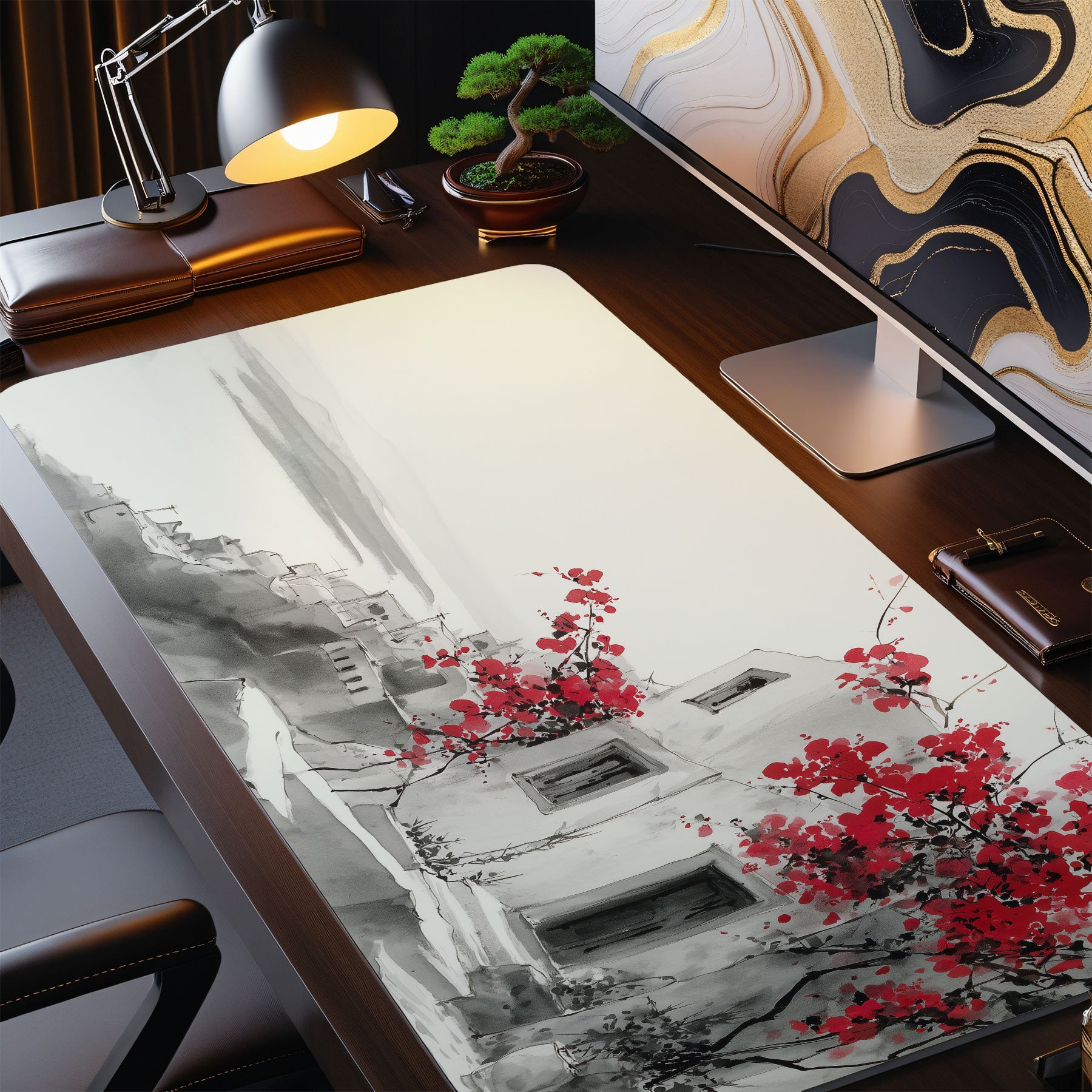 Desk setup with a large desk mat featuring artistic design of buildings and red flowers.
