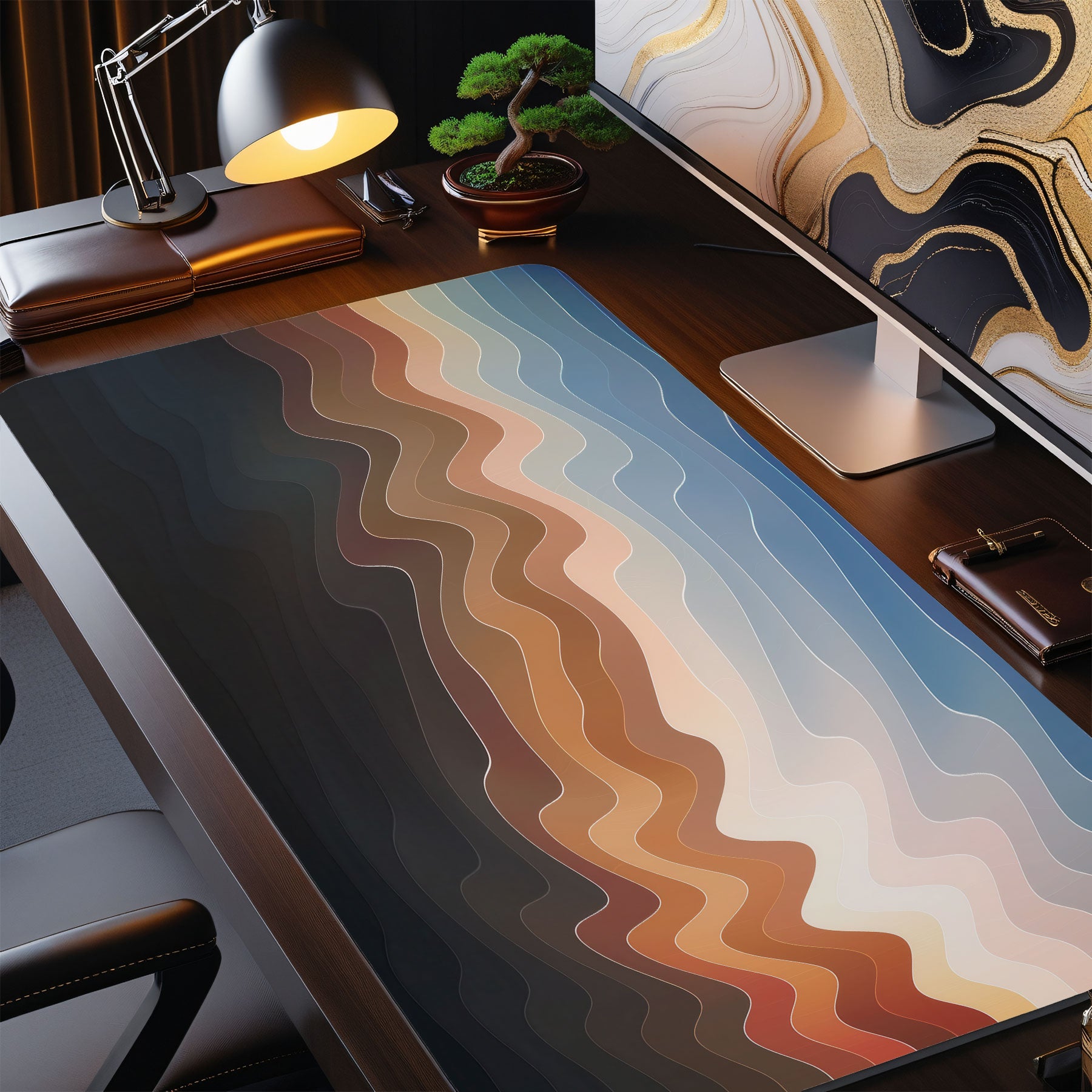 Desk setup with a large mouse pad featuring wavy color patterns, a computer monitor, lamp, and office chair.