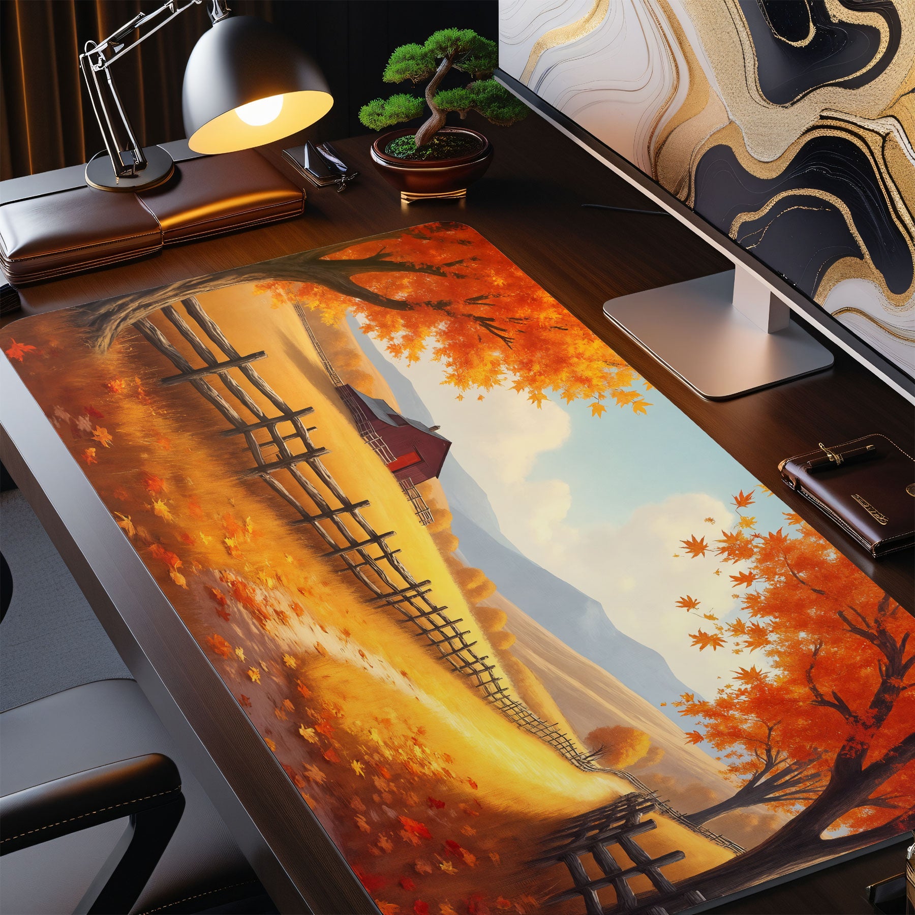 Desk setup with a large desk mat featuring an autumn landscape design.