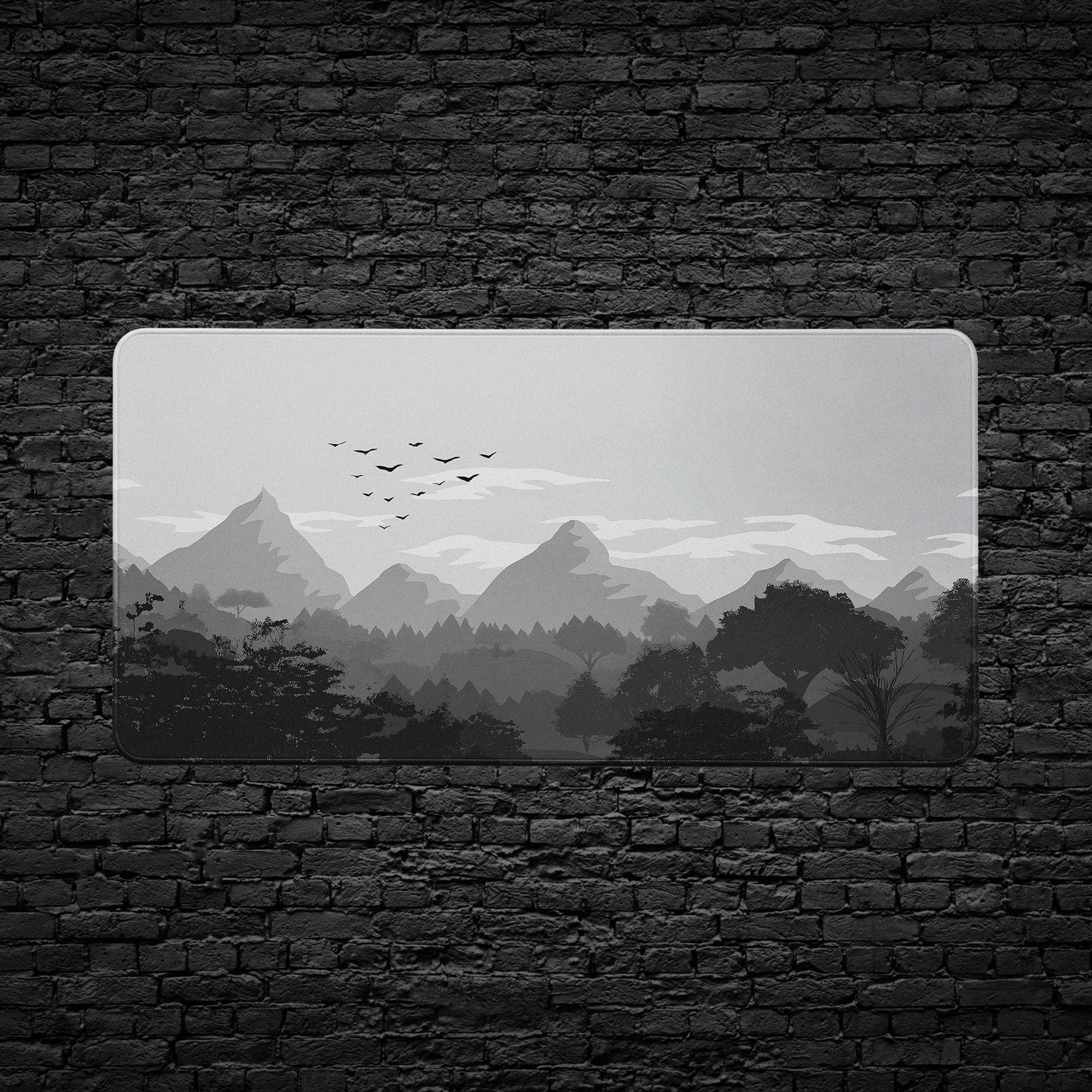 Extended desk mat featuring grayscale mountain scenery.